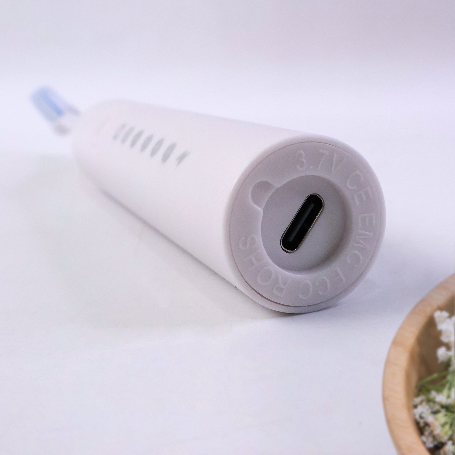 Wukusy rechargeable electric toothbrush in white with three extra brush heads, showing the toothbrush and replacement heads.