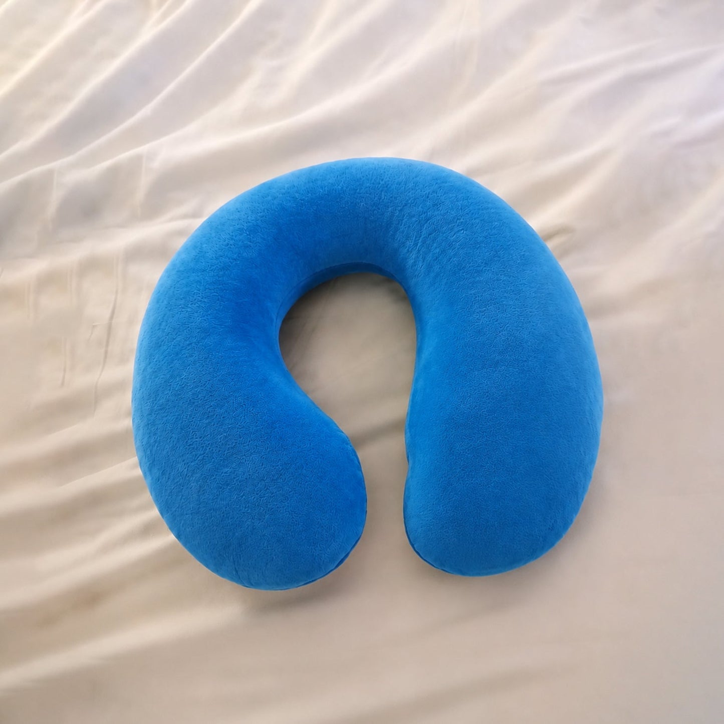 Blue U-shaped soft travel neck pillow by Wukusy, designed for head and neck support during travel.
