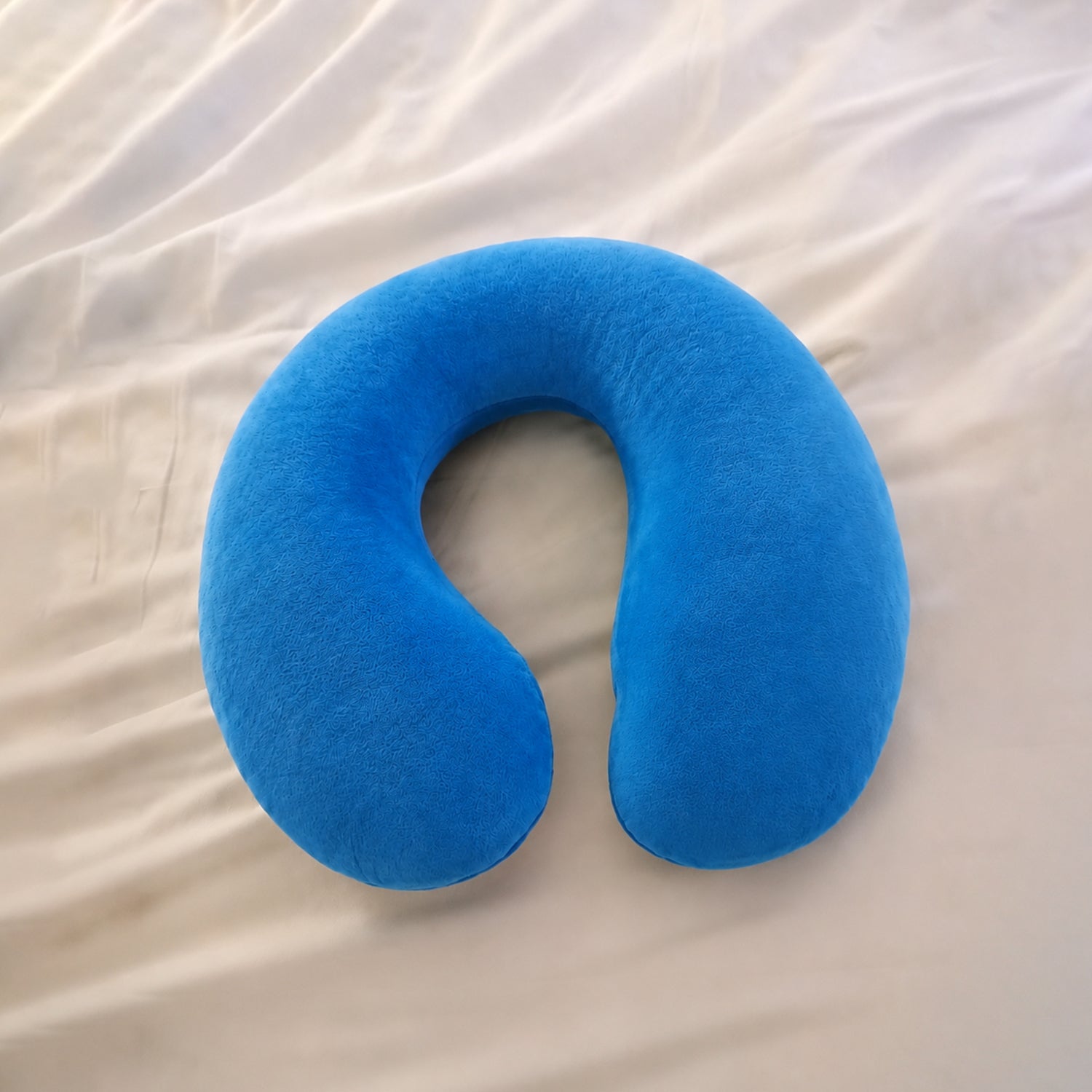 Blue U-shaped soft travel neck pillow by Wukusy, designed for head and neck support during travel.