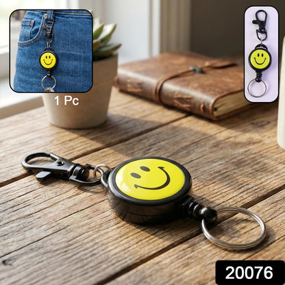Wukusy smiley face retractable keychain with bright yellow design and cheerful smile, attached to keys or bags.