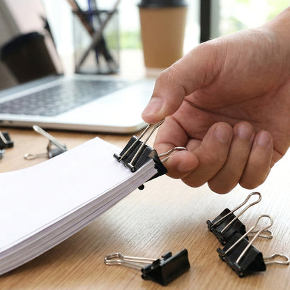 Set of 12 black 25mm binder clips by Wukusy, showing sturdy metal handles and compact size for organizing papers.