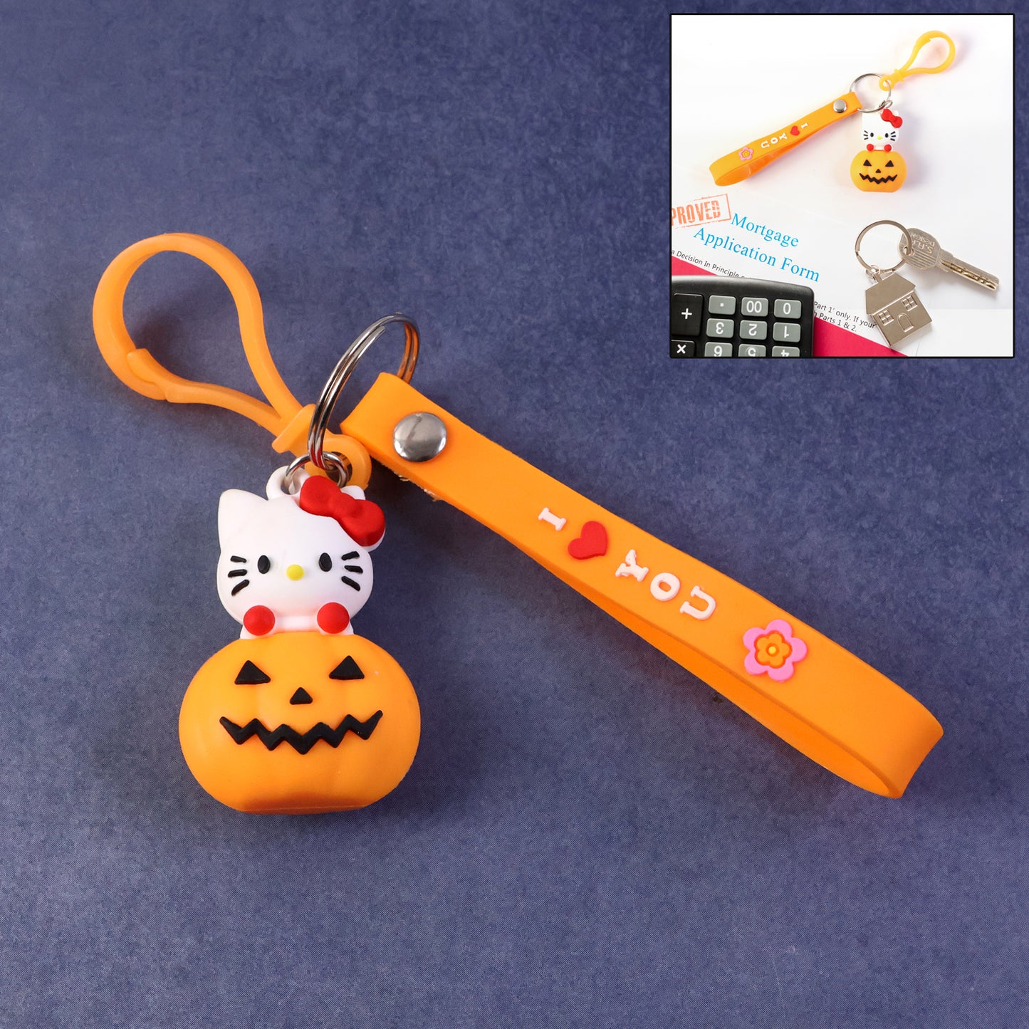 Cute cartoon cat pumpkin silicone keychain by Wukusy featuring a playful cat design on an orange pumpkin-shaped accessory.