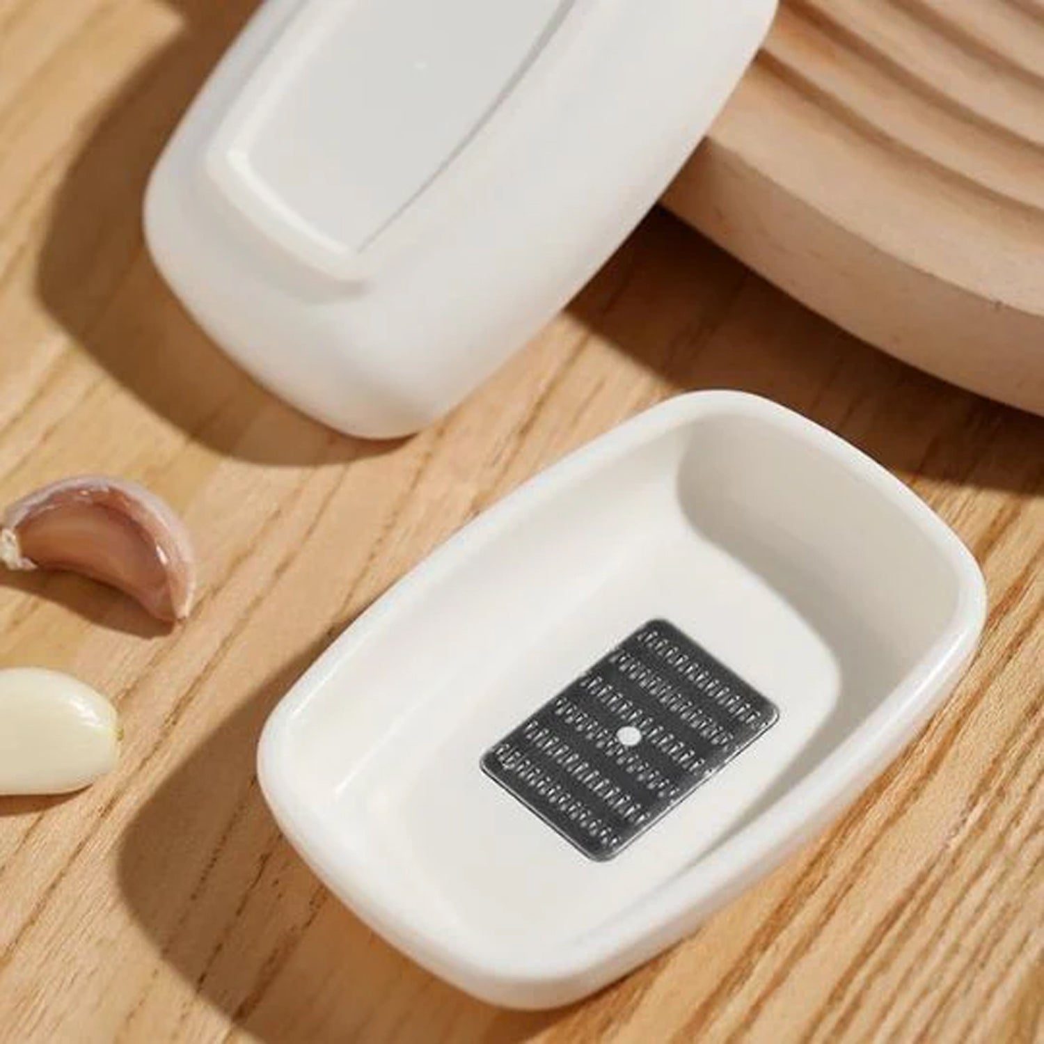Wukusy multipurpose garlic and ginger grinding plate showing textured surface for crushing and grinding spices.
