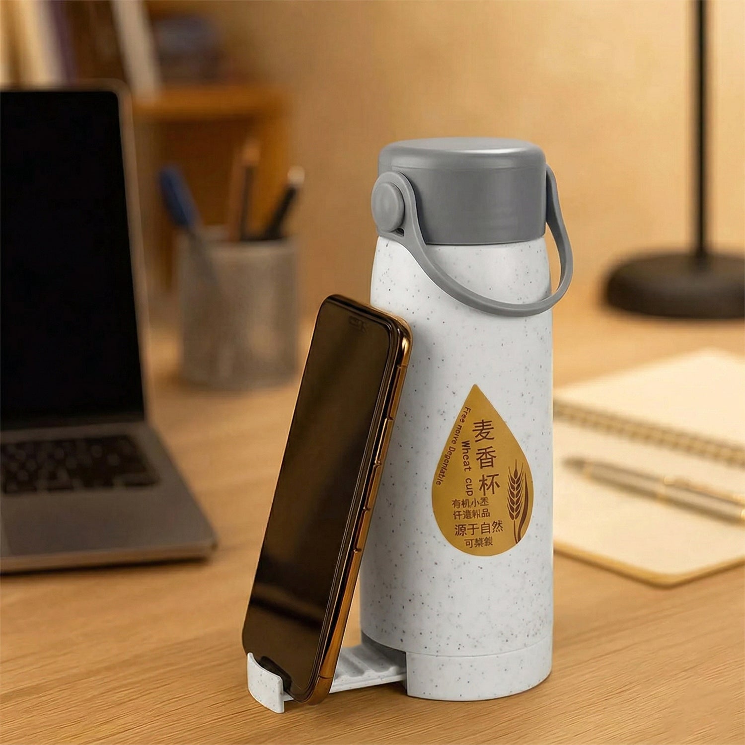 Wukusy premium glass water bottle with mobile phone holder, 380ml, clear glass and black lid, shown with phone holder attachment.