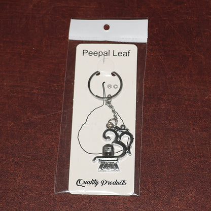 Wukusy Om with Shivling metal keychain featuring intricate design, shiny silver finish, and compact size.