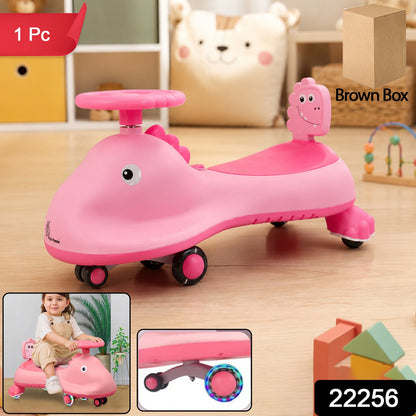Pink shark-themed kids swing car ride-on toy with music, featuring a twist design for active play by Wukusy.