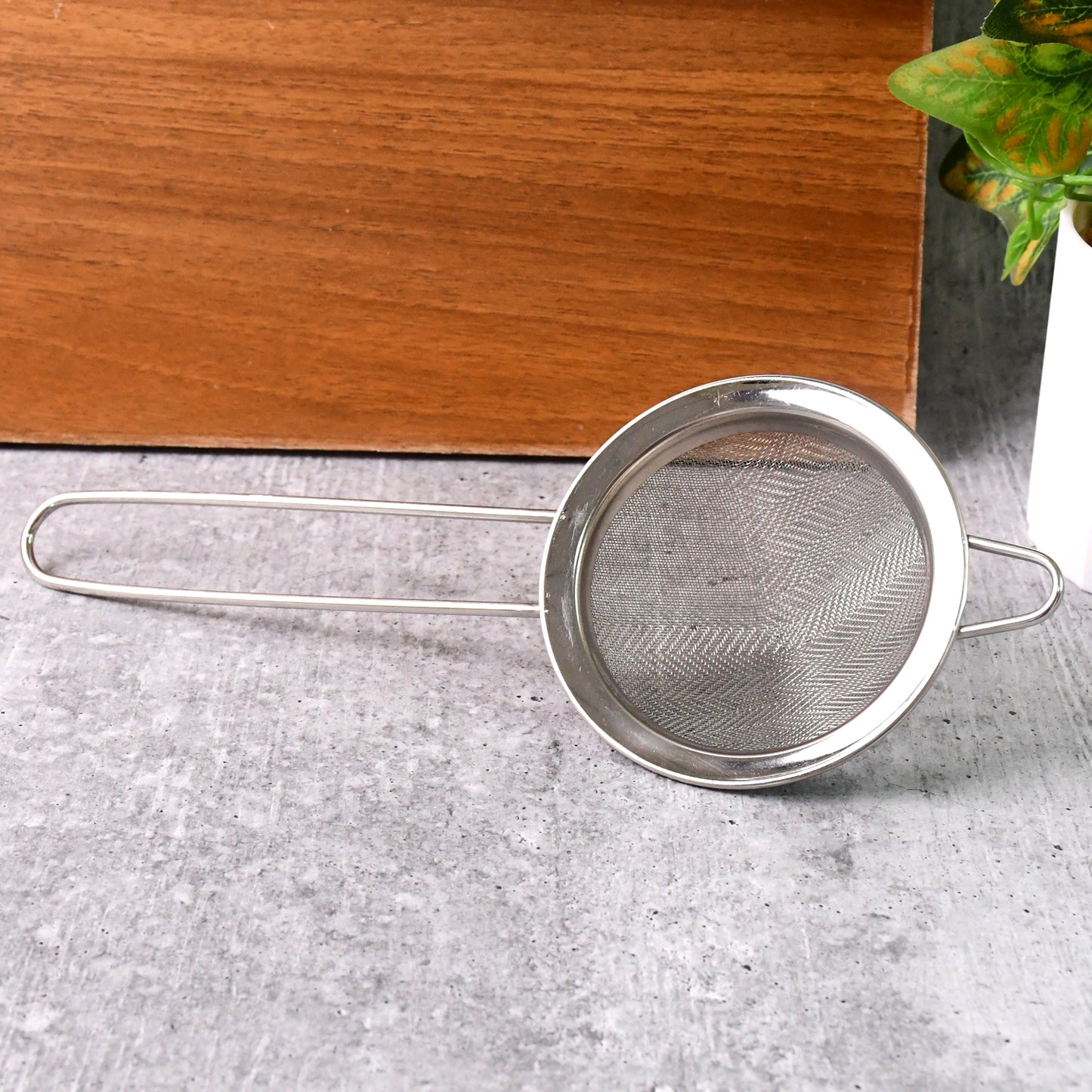Supermom Slim stainless steel strainer by Wukusy, designed for kitchen use, with a fine mesh for filtering liquids and small particles.