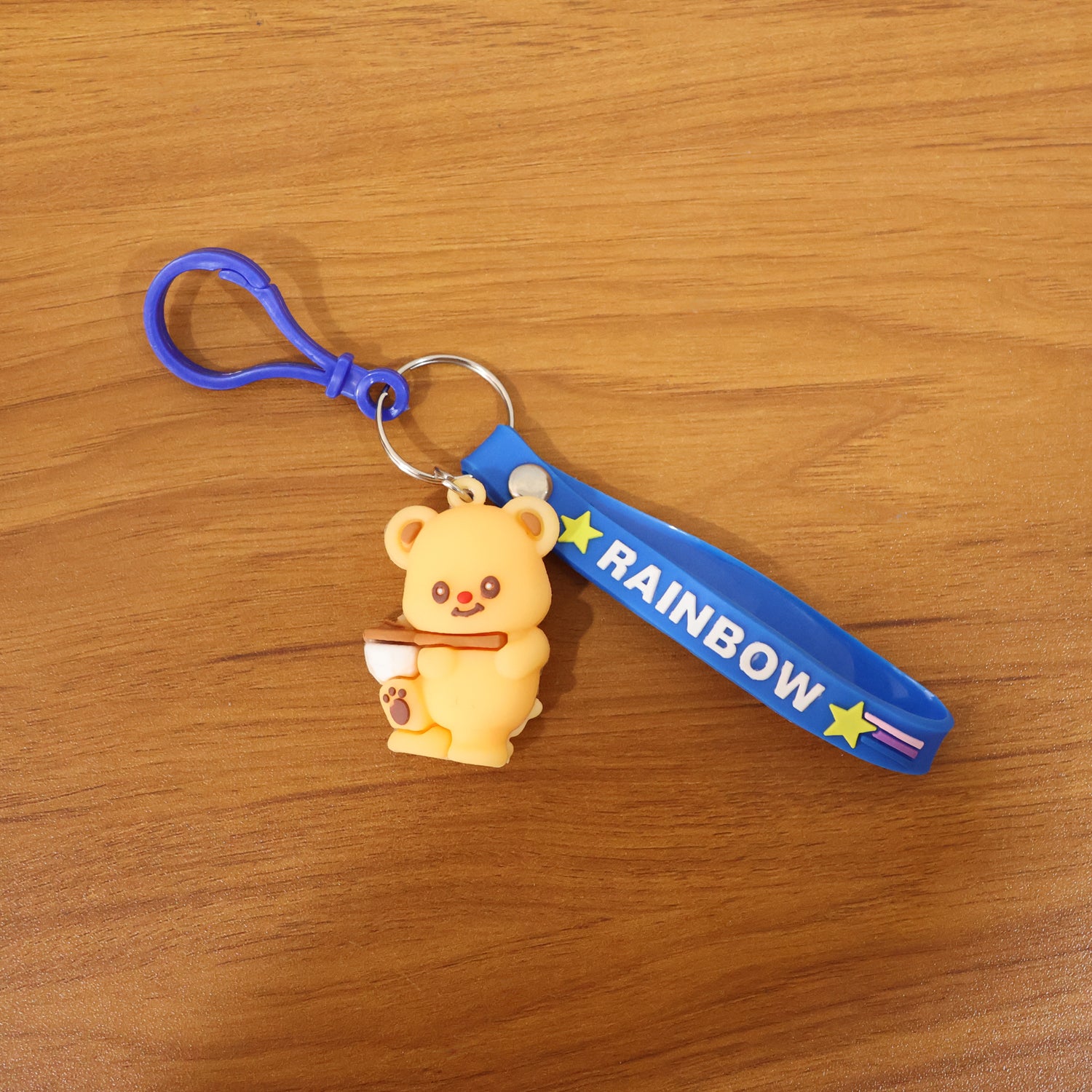 Cute bear character keychain by Wukusy featuring a plush-style bear with a smiling face and a metal keyring attachment.