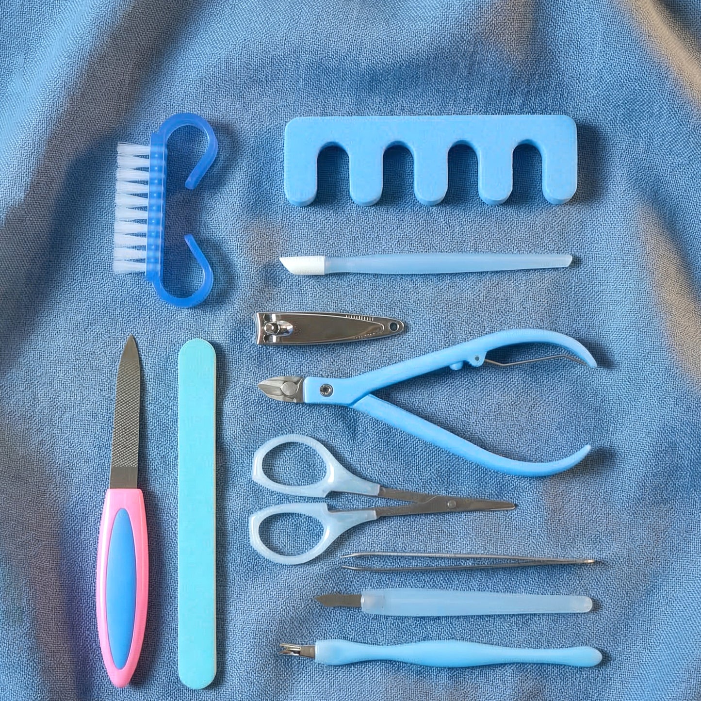 Wukusy 11-in-1 manicure and pedicure nail care kit with various tools for grooming and nail maintenance.