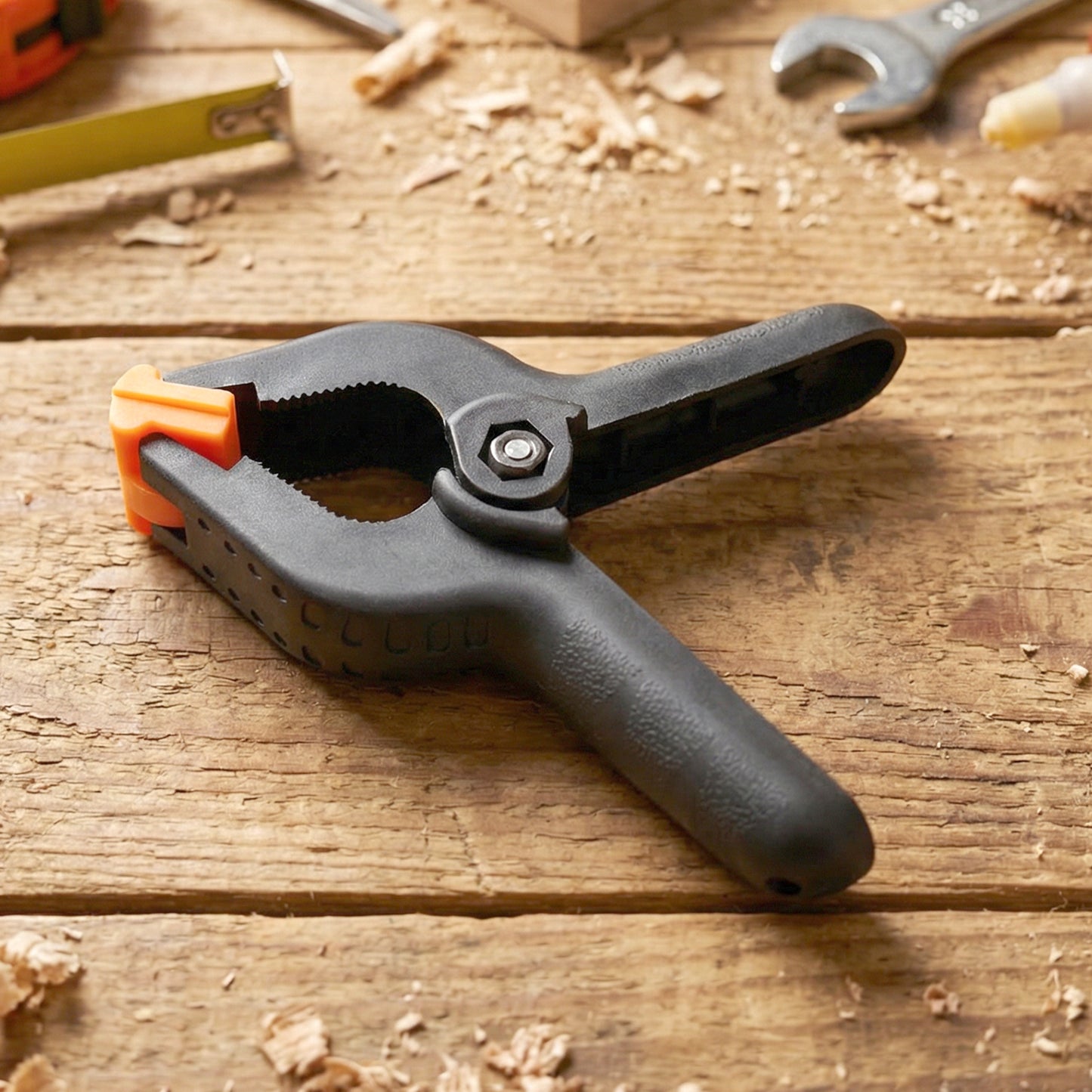 Heavy-duty Wukusy spring clamp shown gripping a piece of wood, ideal for woodworking and DIY projects.