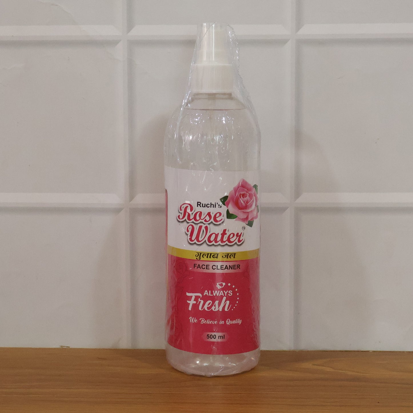 Wukusy rose water face cleanser spray bottle, 500ml, with a clear spray top and pink rose design on the bottle.