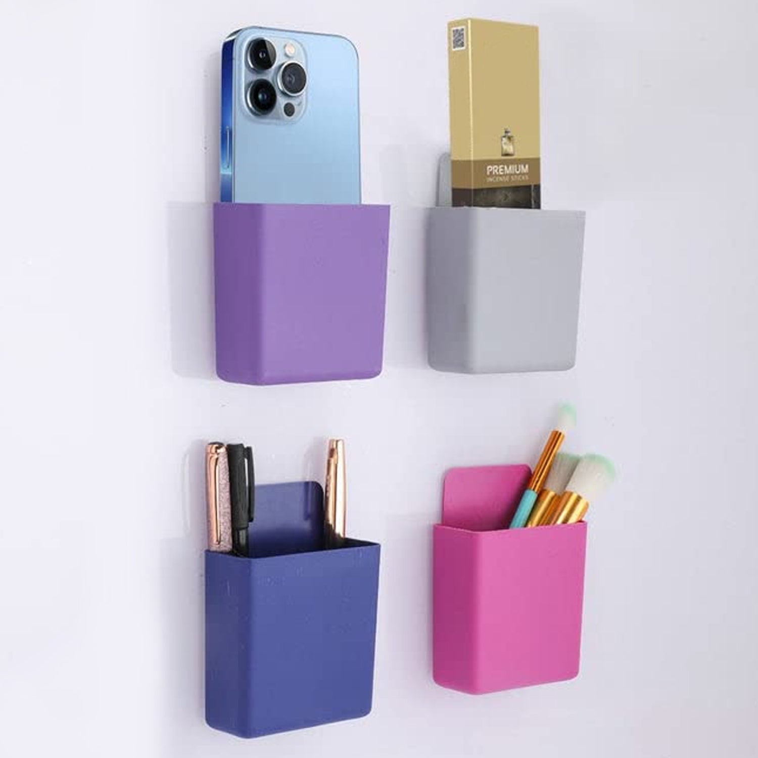 Set of four Wukusy multipurpose plastic wall-mounted remote and mobile holder stands, compact and easy to install.