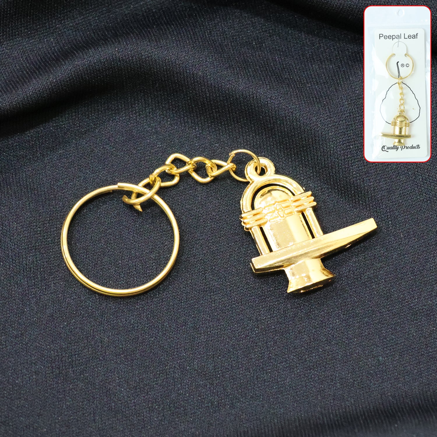 Golden metal Shivling keychain from Wukusy featuring intricate design, compact size, and shiny finish.