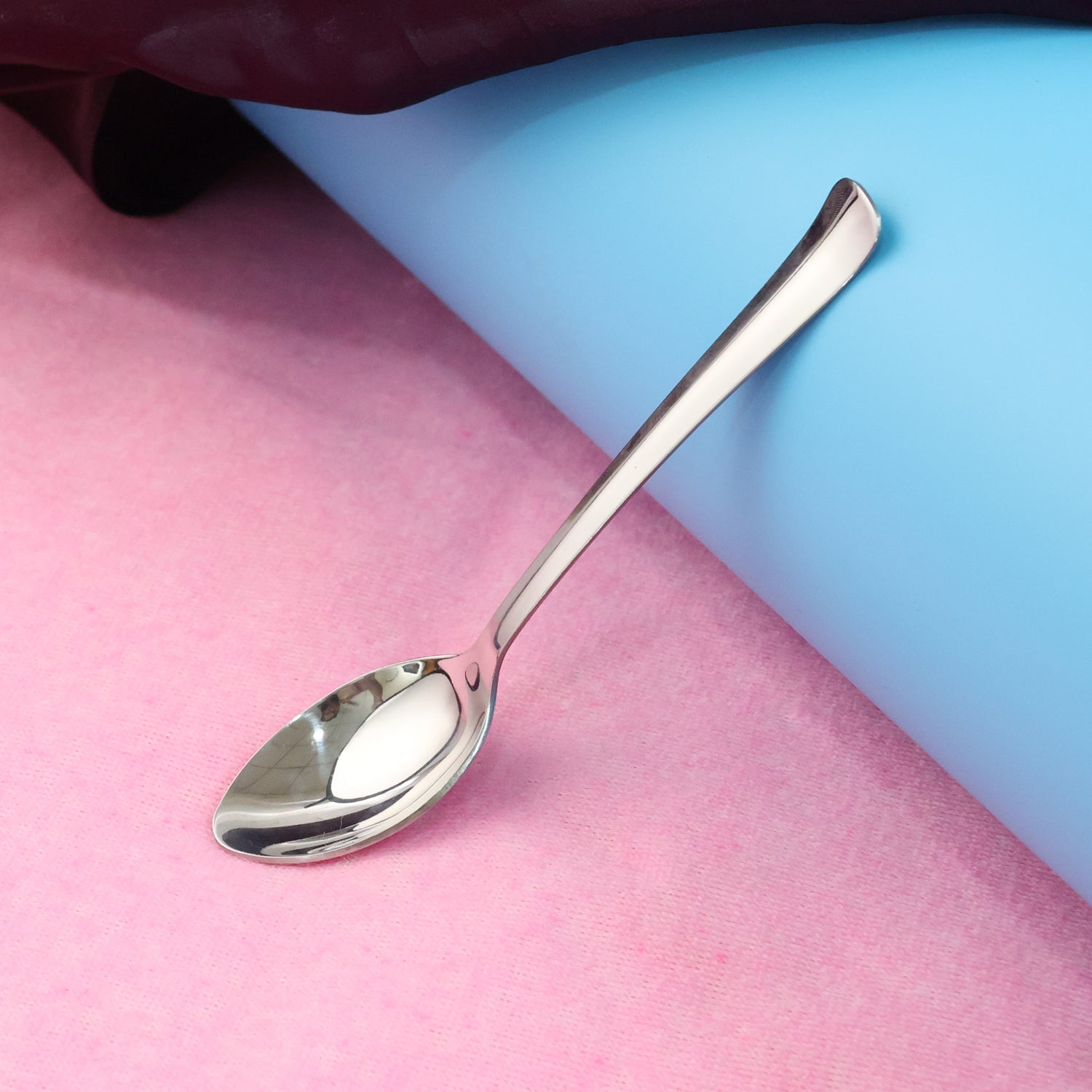 Wukusy stainless steel baby dining spoon with ergonomic handle, suitable for infants and toddlers in a home and kitchen setting.