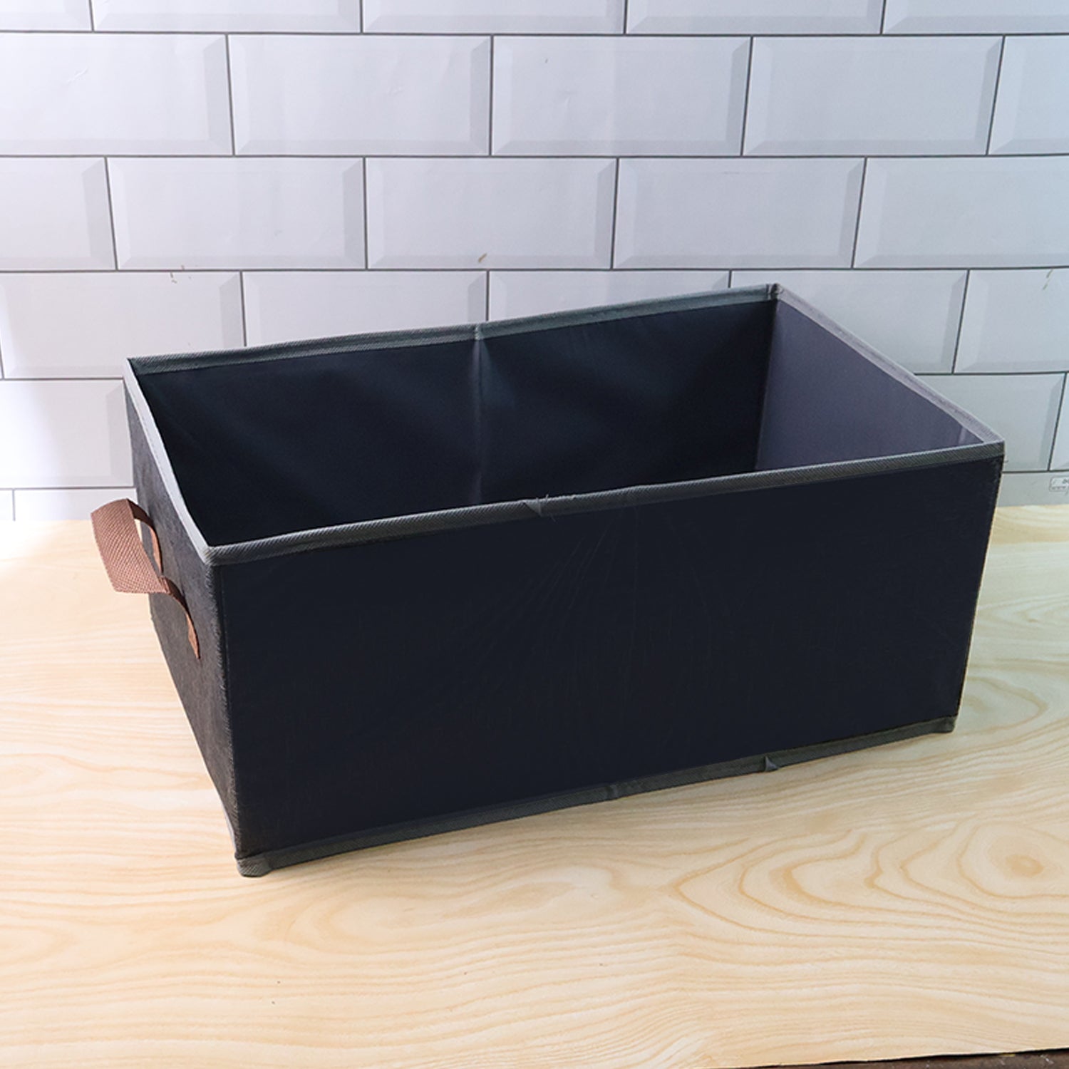 Foldable rectangular Wukusy travel storage box with handle, 46x28 cm, shown in a compact, foldable state with a sturdy handle.