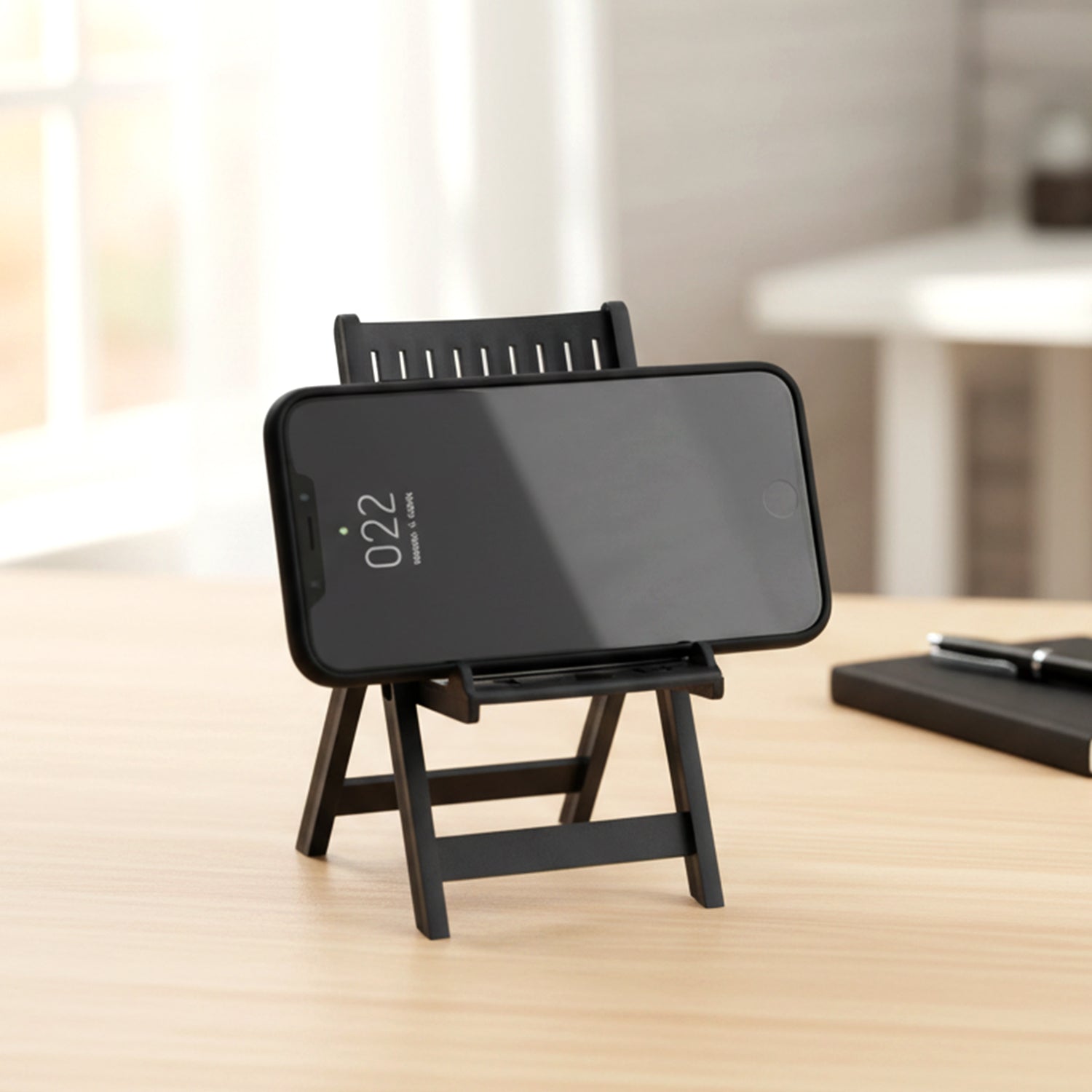 Black Wukusy mini chair-shaped mobile stand holder for smartphones, compact and stylish for desk or bedside use.