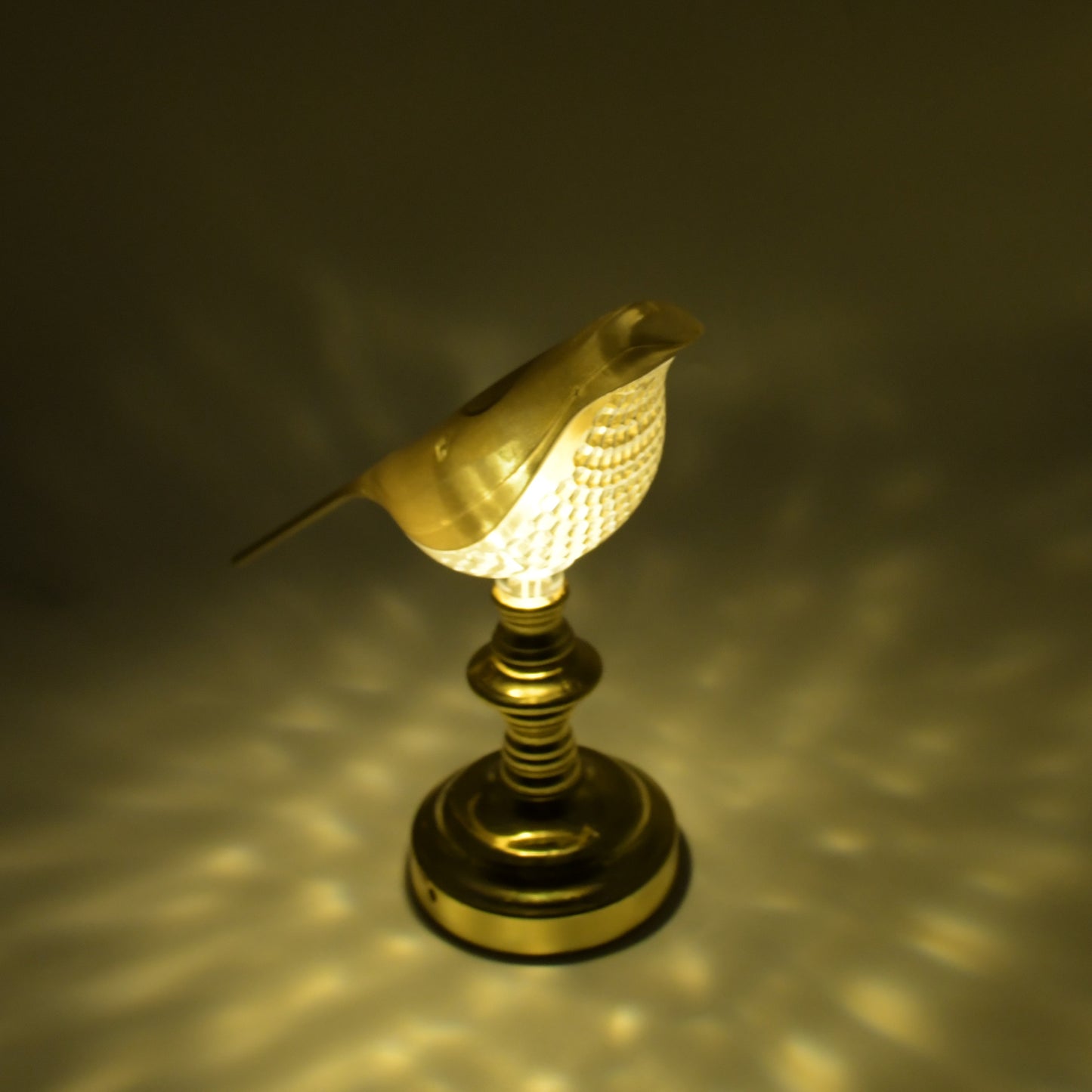 Wukusy 8442 Sparrow LED table lamp with crystal decoration, soft light, energy-saving home decor lamp on a wooden surface.