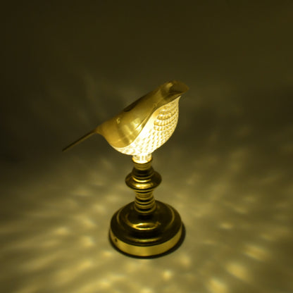 Wukusy 8442 Sparrow LED table lamp with crystal decoration, soft light, energy-saving home decor lamp on a wooden surface.