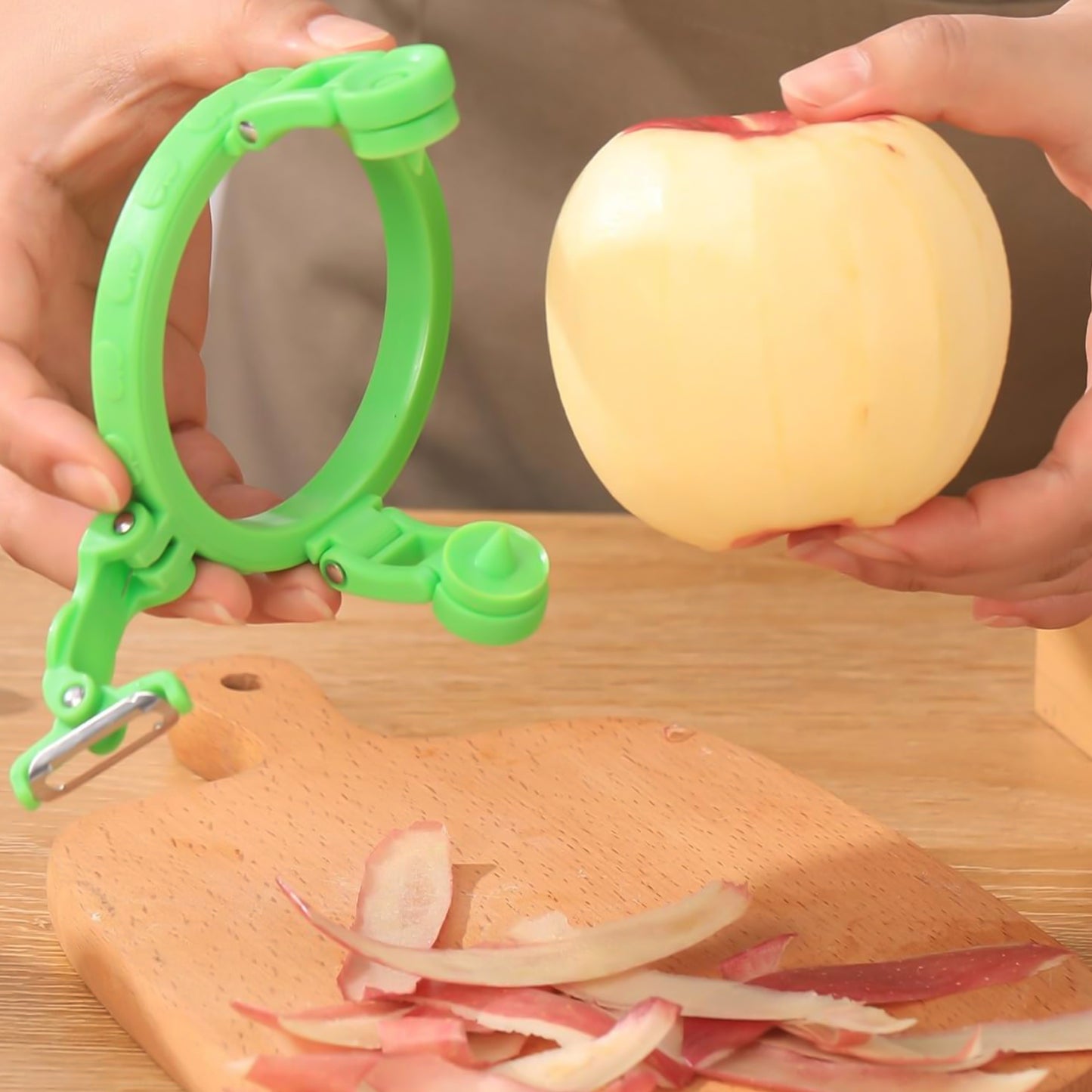 Wukusy adjustable apple peeler cutter with holder ring, kitchen tool for peeling, slicing, and coring apples.