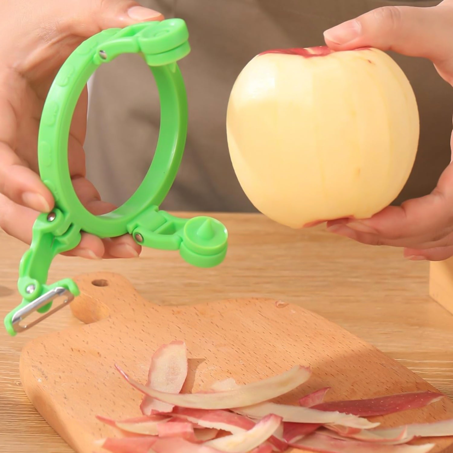 Wukusy adjustable apple peeler cutter with holder ring, kitchen tool for peeling, slicing, and coring apples.