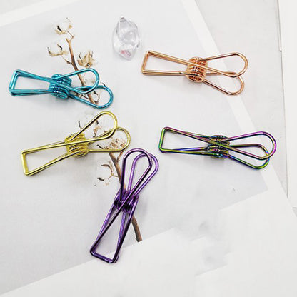 Sturdy stainless steel Wukusy clothes hanging clips for laundry and home organization, showing multiple clips attached to a clothesline.