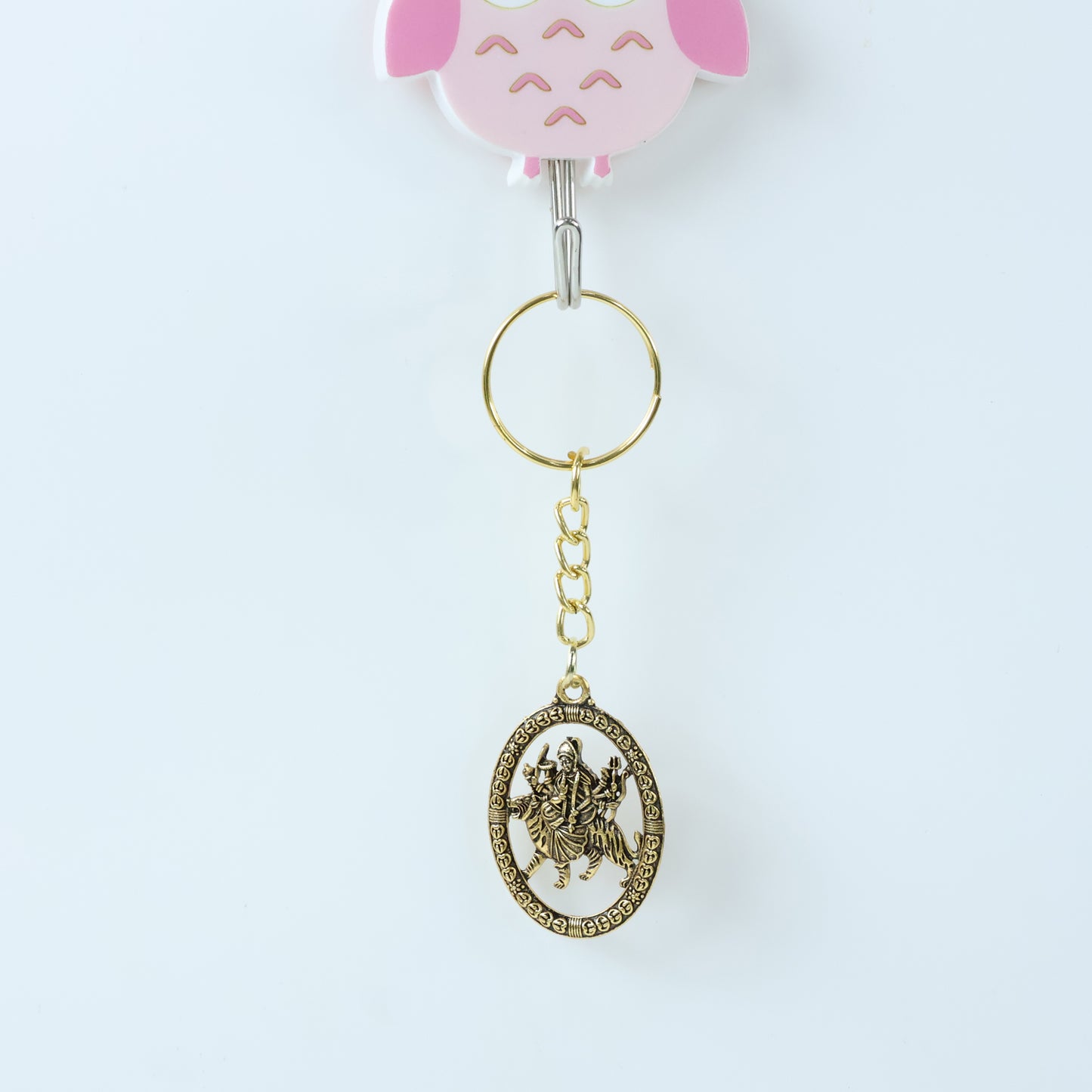 Golden Maa Durga oval frame keychain by Wukusy featuring an intricate design and compact size.