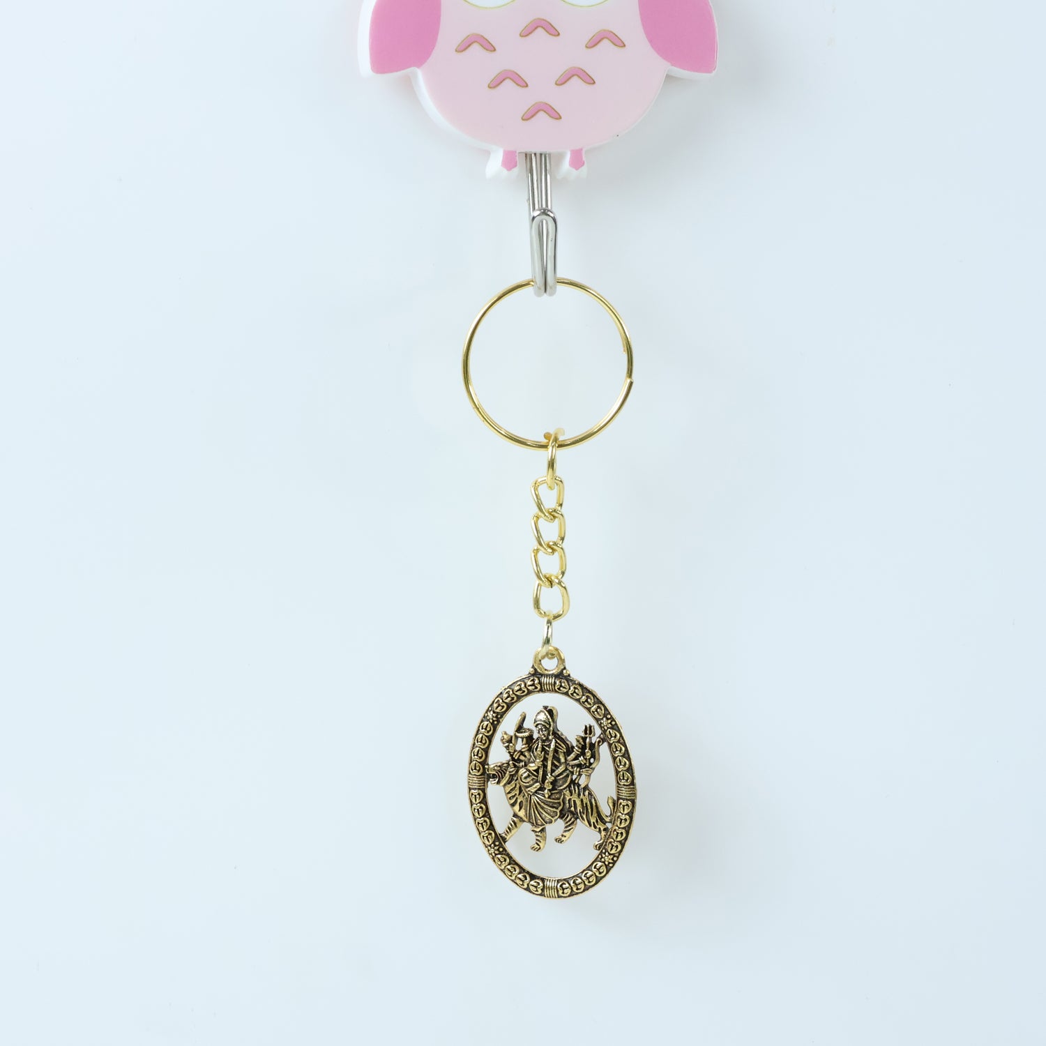 Golden Maa Durga oval frame keychain by Wukusy featuring an intricate design and compact size.