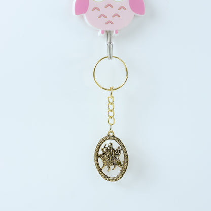 Golden Maa Durga oval frame keychain by Wukusy featuring an intricate design and compact size.