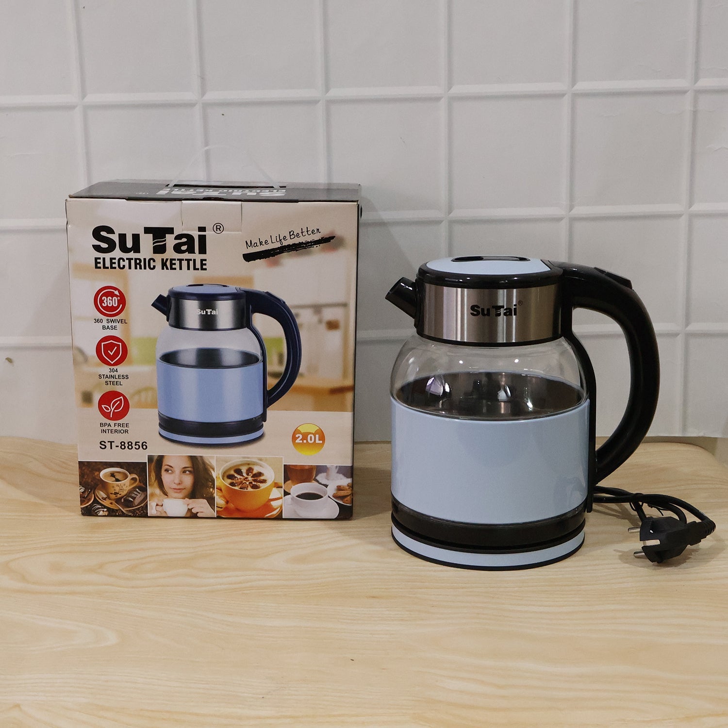 Wukusy Suta electric glass kettle with 2L stainless steel body, hot water boiler for tea, on kitchen countertop.