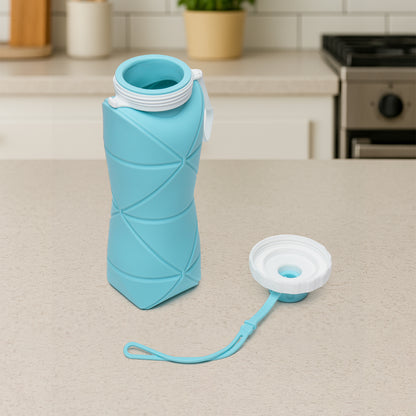Wukusy 600ml collapsible silicone water bottle for travel, sports, gym, and office use, shown in compact, foldable form with lid.