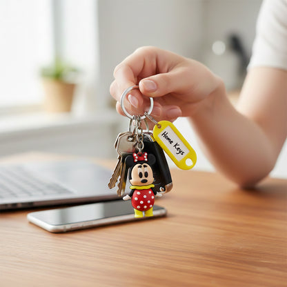 Colorful cartoon character keychain with a customizable name tag, featuring playful mixed design by Wukusy.