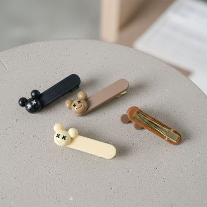 Set of four cute cartoon bear design premium fashion hair clips by Wukusy, featuring colorful bear illustrations on each clip.