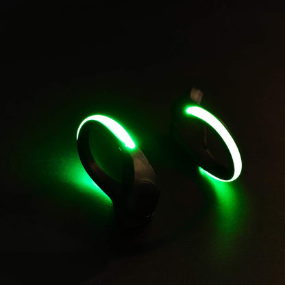 Pair of Wukusy LED shoes clip lights showing colorful illumination on shoe sides for added visibility and style.