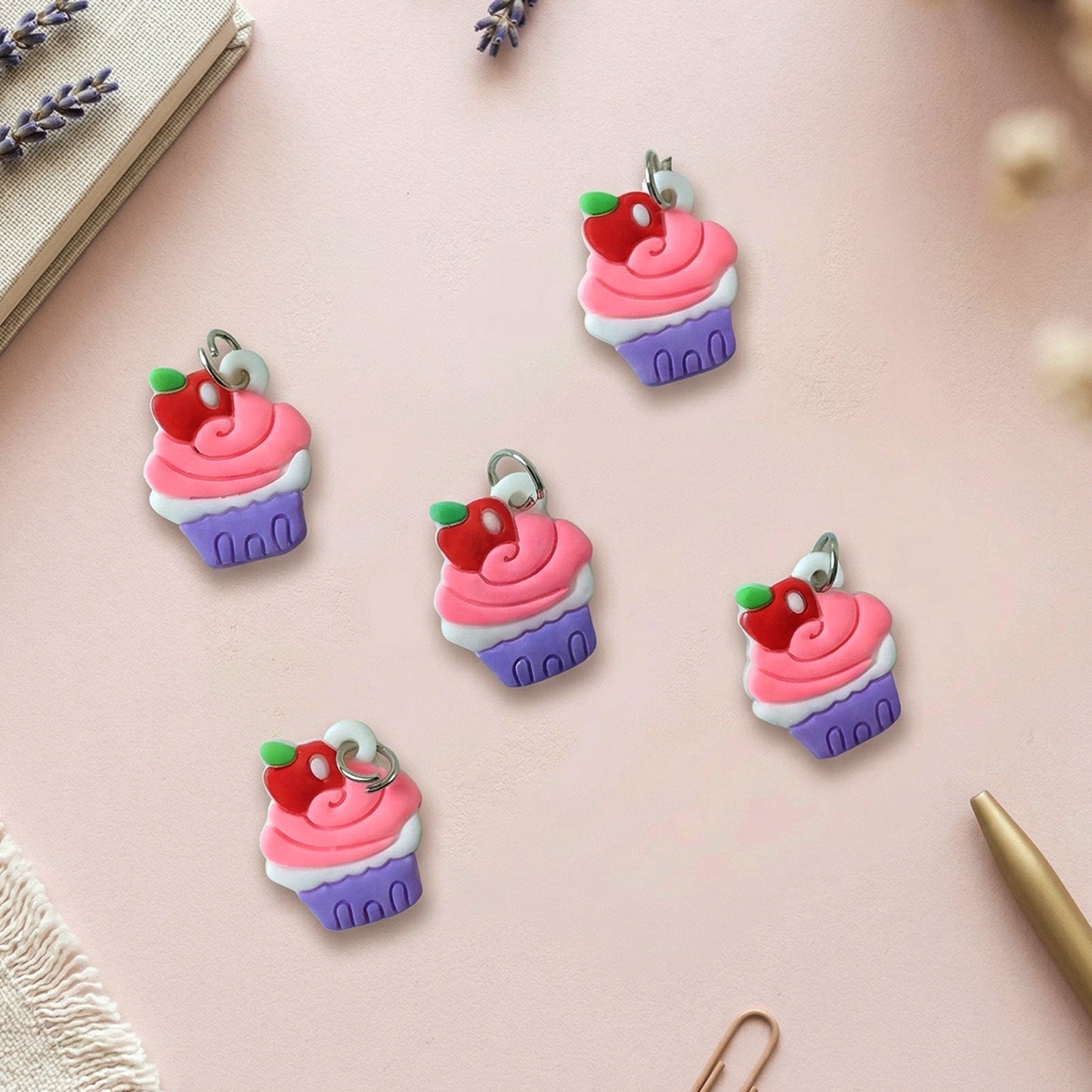 Set of 10 Wukusy cupcake-shaped bag charm keychains with colorful, cute dessert designs on a white background.