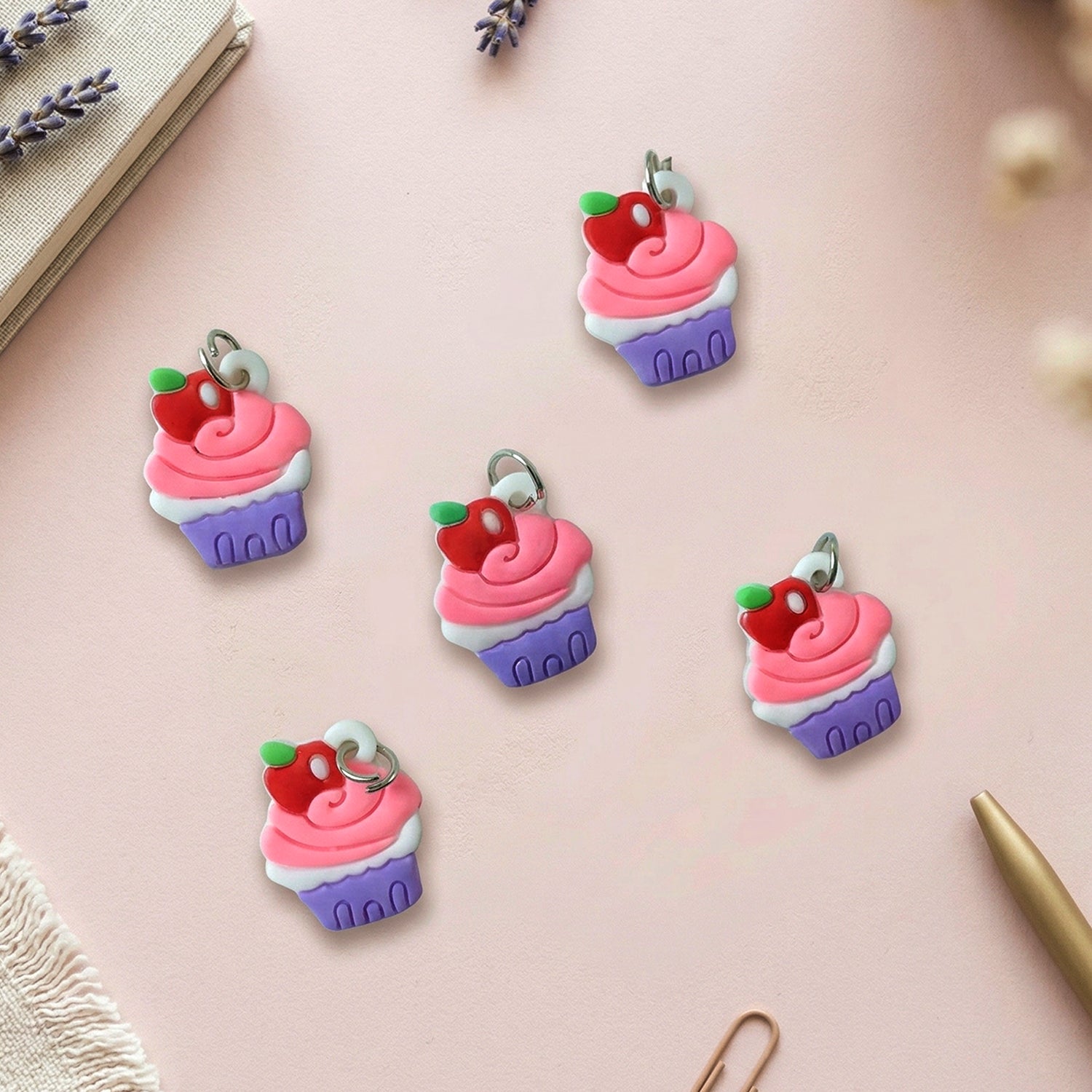 Set of 10 Wukusy cupcake-shaped bag charm keychains with colorful, cute dessert designs on a white background.