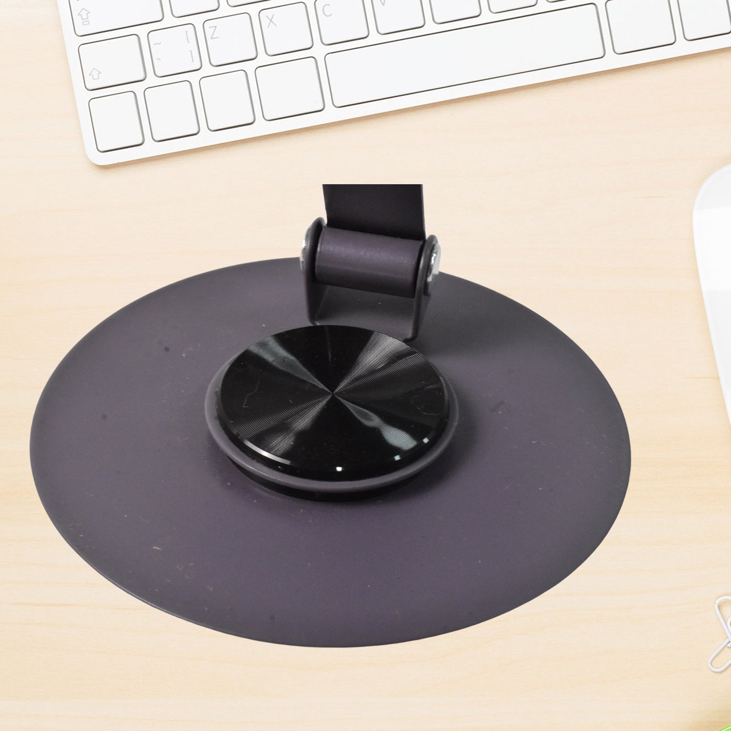 Foldable metal mobile stand from Wukusy holding a smartphone, compact and adjustable for hands-free viewing.