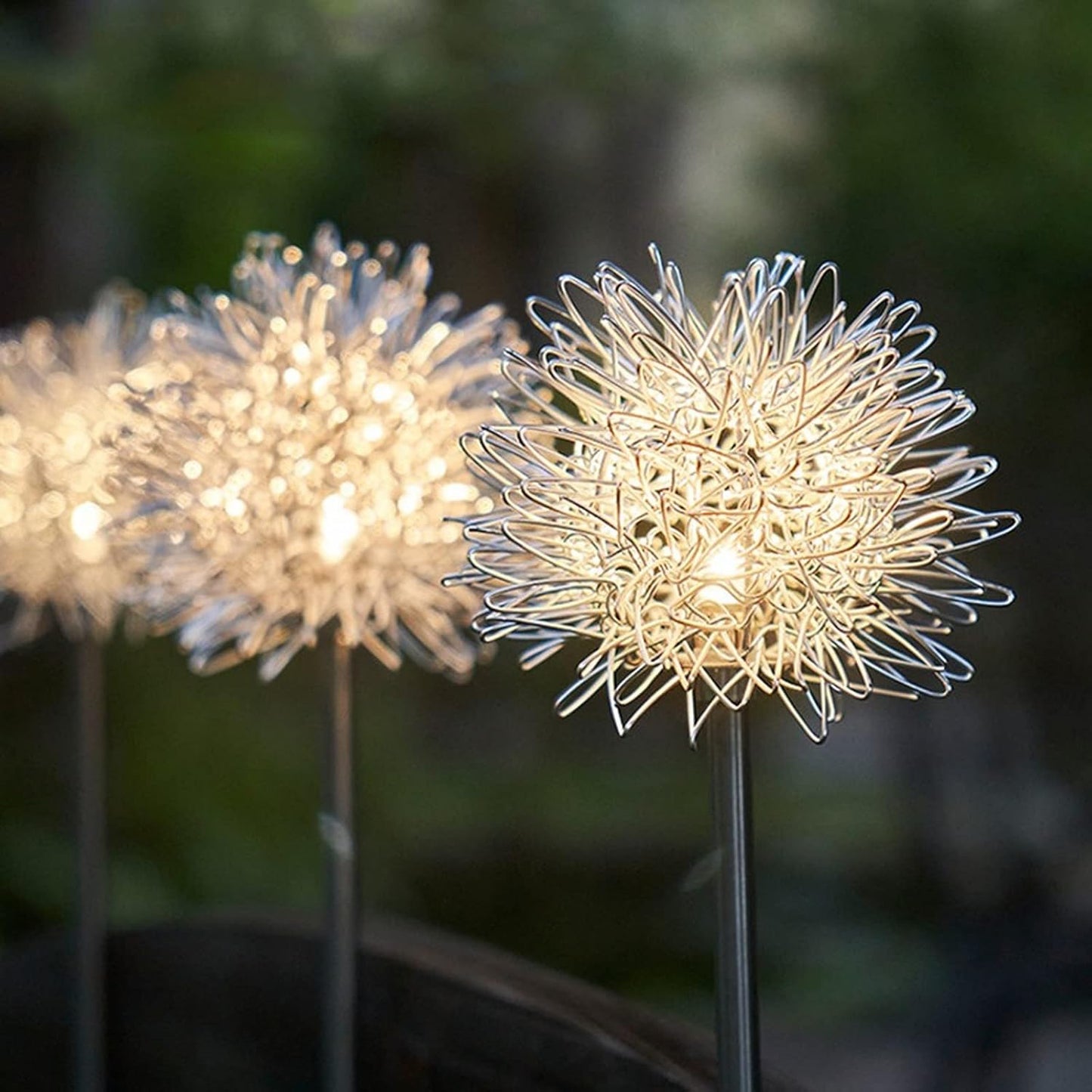 Two Wukusy solar-powered dandelion garden lights illuminating a garden at dusk with a soft glow