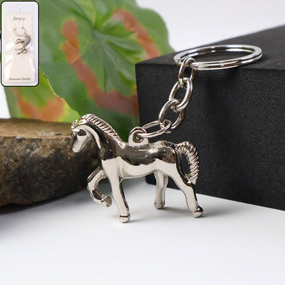 Shiny metallic horse-shaped keychain from Wukusy, featuring a detailed horse design on a silver finish keyring.