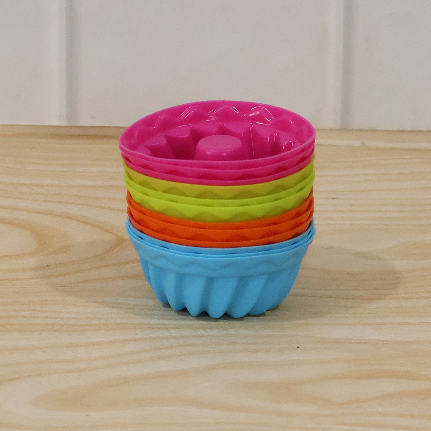 Reusable Wukusy silicone cupcake mold set with 12 colorful, flexible baking cups for making cupcakes and desserts.