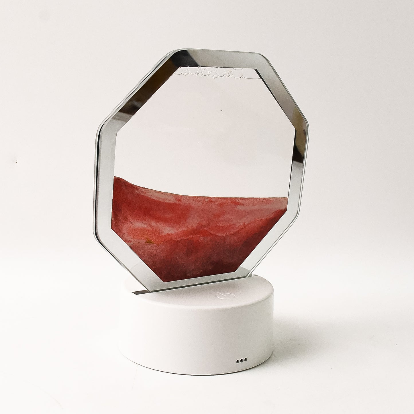 Wukusy LED moving sand art table lamp on office desk, with colorful flowing sand creating dynamic patterns in a modern setting.