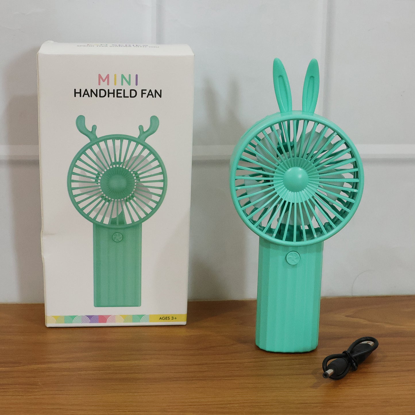 Wukusy portable mini handheld fan with cute bunny ear design, USB rechargeable and compact for personal cooling.