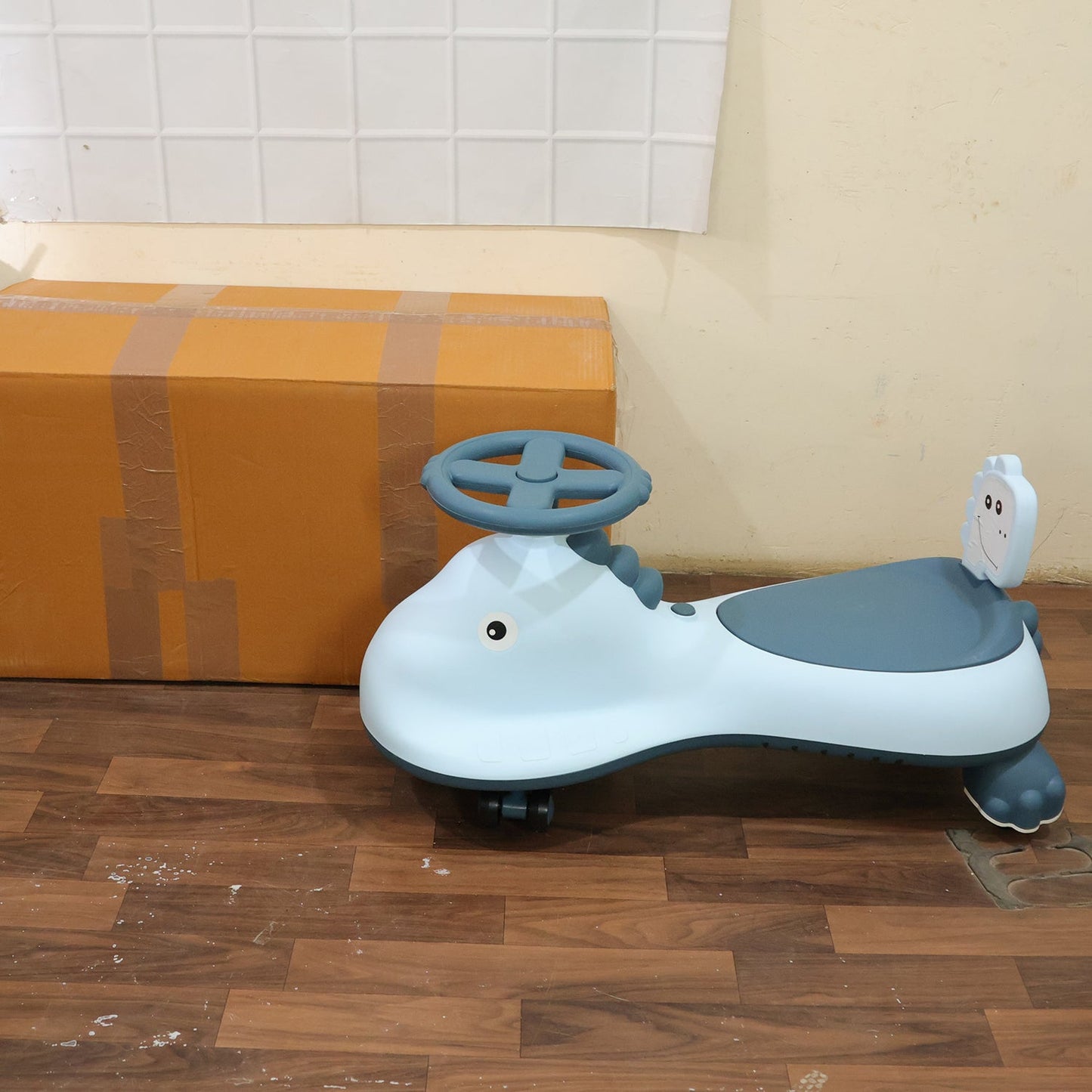 Blue shark-themed kids swing car ride-on toy by Wukusy with music, featuring a magic twist design for active play.