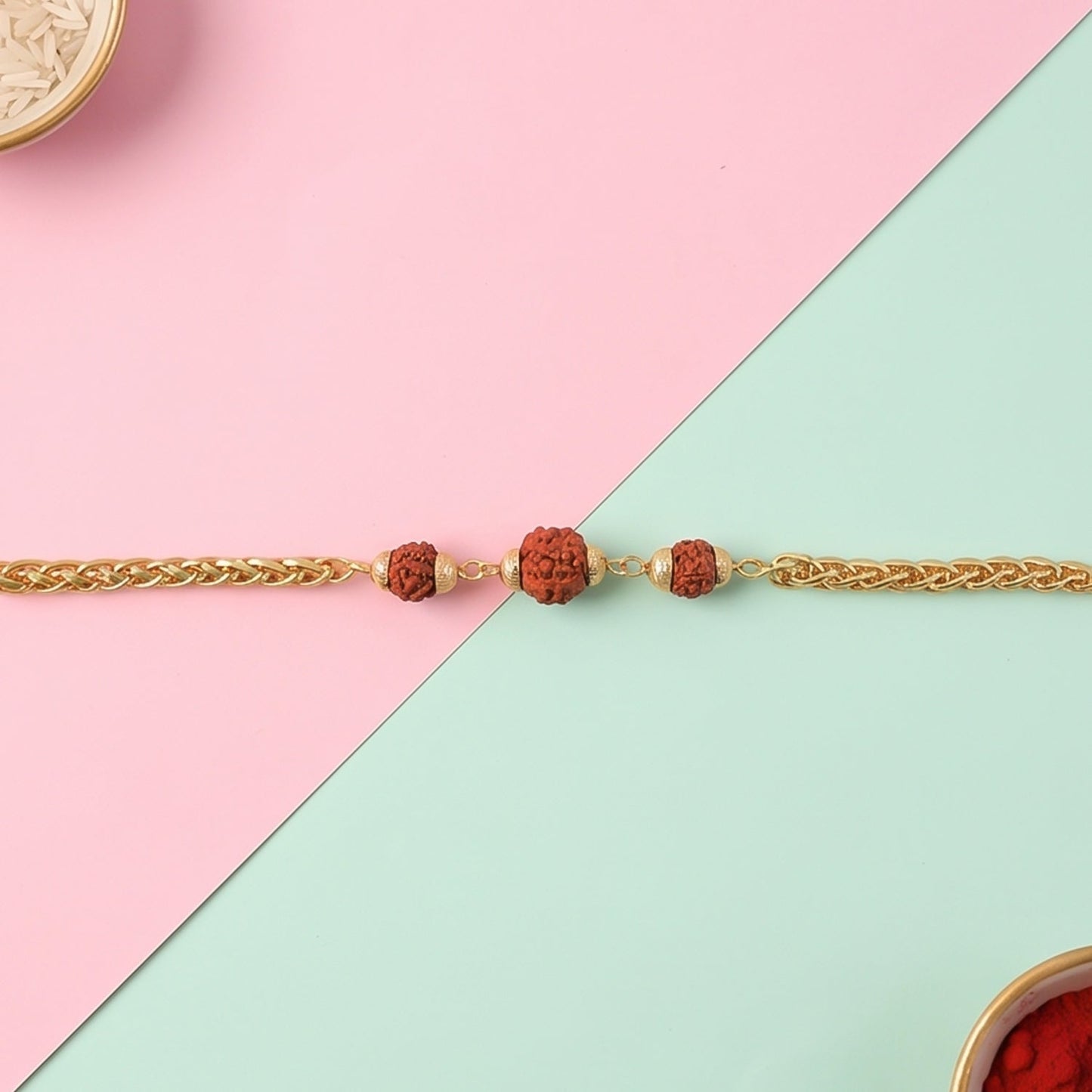 Gold-plated Rudraksha bead Rakhi on a chain for brother, featuring intricate design and craftsmanship by Wukusy.