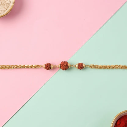 Gold-plated Rudraksha bead Rakhi on a chain for brother, featuring intricate design and craftsmanship by Wukusy.