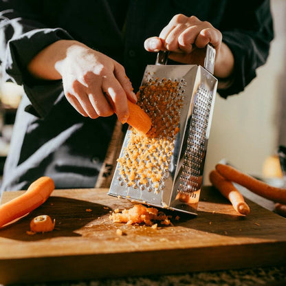 Wukusy Supermom 5-in-1 stainless steel grater and slicer for kitchen use, featuring multiple blades for versatile food preparation.