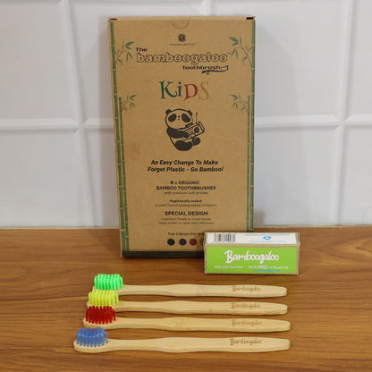 Wukusy bamboo toothbrush set for adults with four eco-friendly toothbrushes featuring natural bamboo handles and soft bristles.