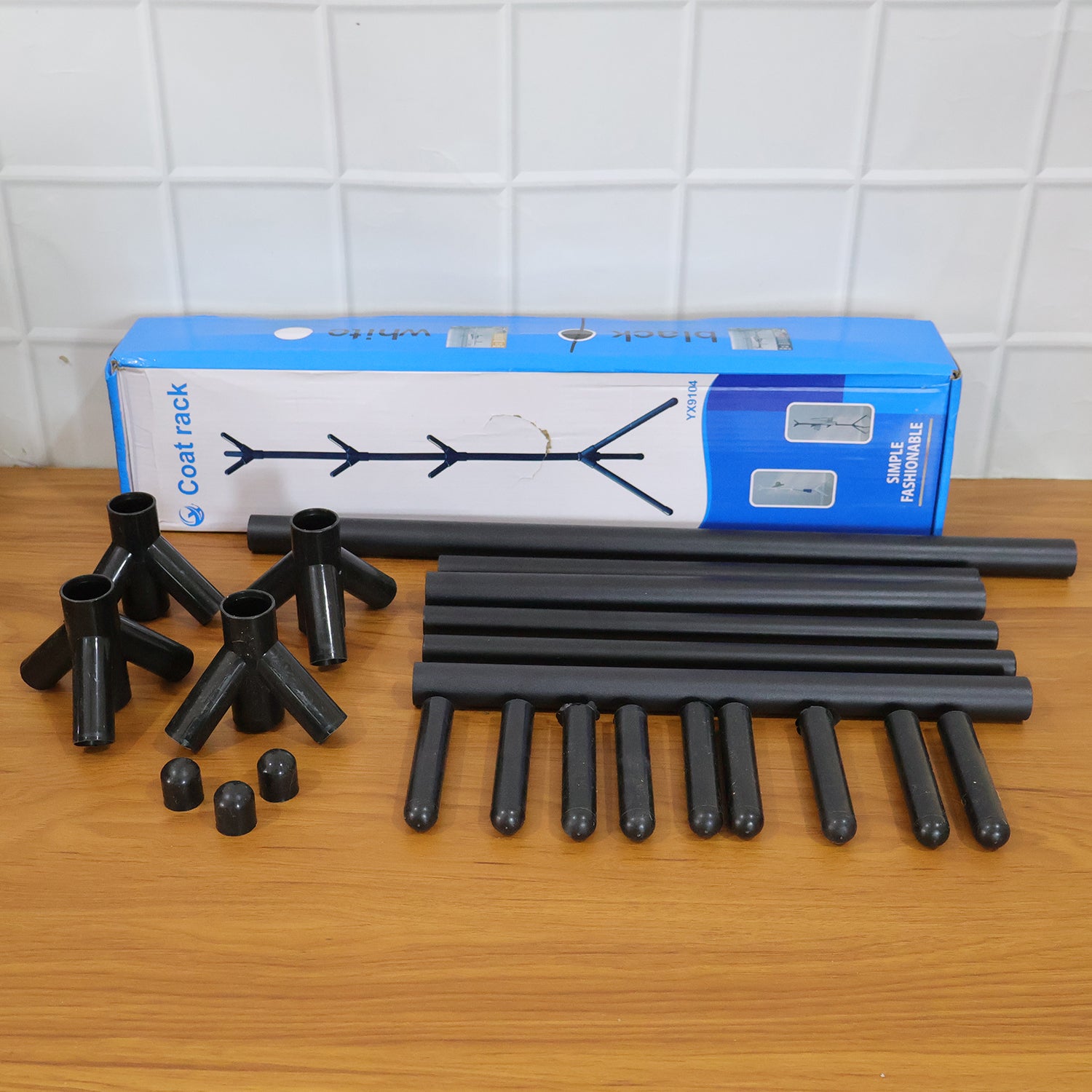 Wukusy floor standing metal coat rack stand with multiple hooks for hanging coats, hats, and accessories in a modern home or office.