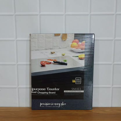 Wukusy stainless steel chopping board, 35.5x29 cm, 1mm thick, on a kitchen countertop with knives and vegetables.