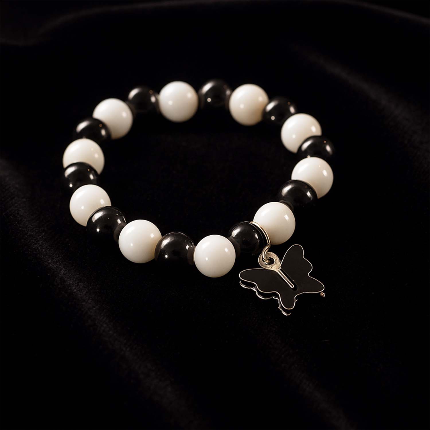Elegant black and white fancy bracelet by Wukusy featuring intricate design and stylish appearance, displayed on a neutral background.