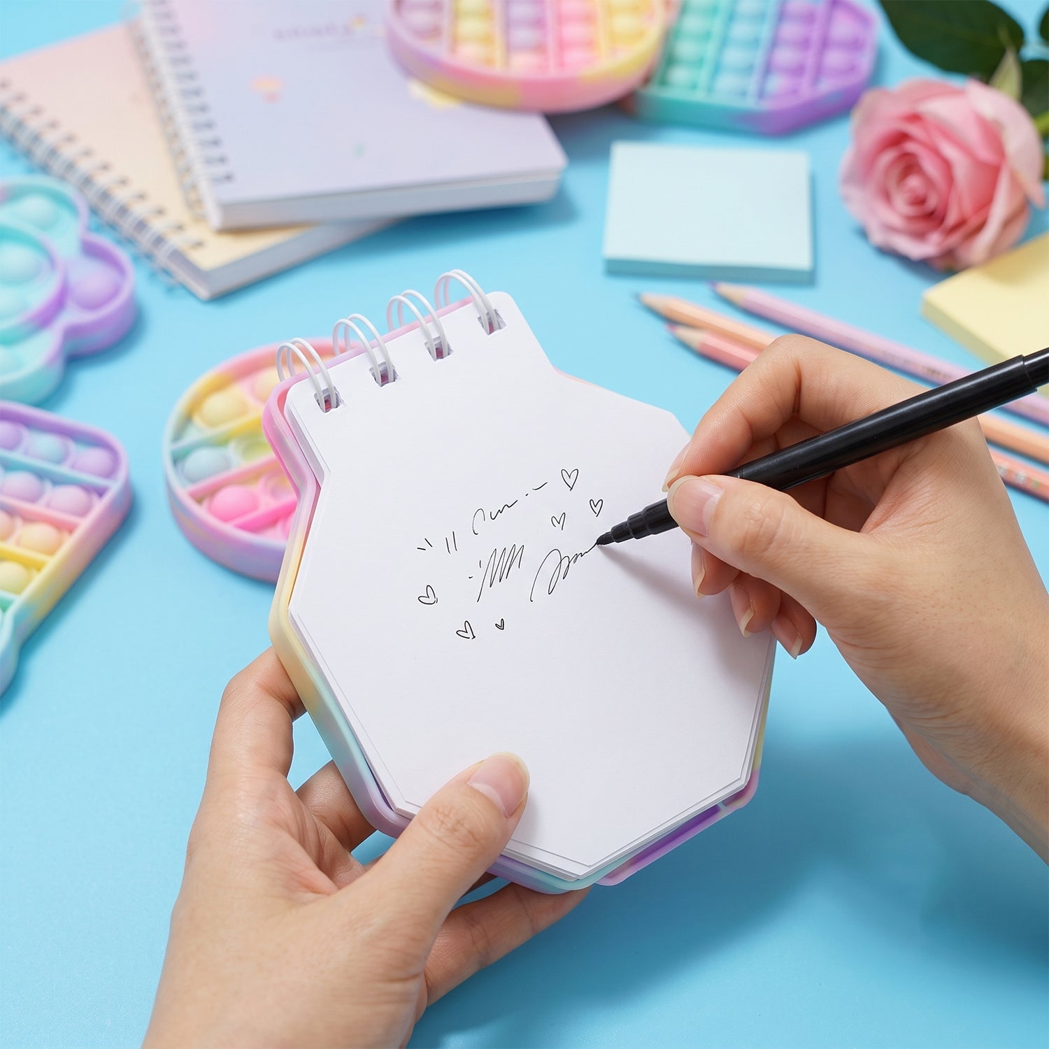 Pastel hexagon bubble pop fidget diary by Wukusy, a kids' notebook with colorful push bubbles for sensory fun.